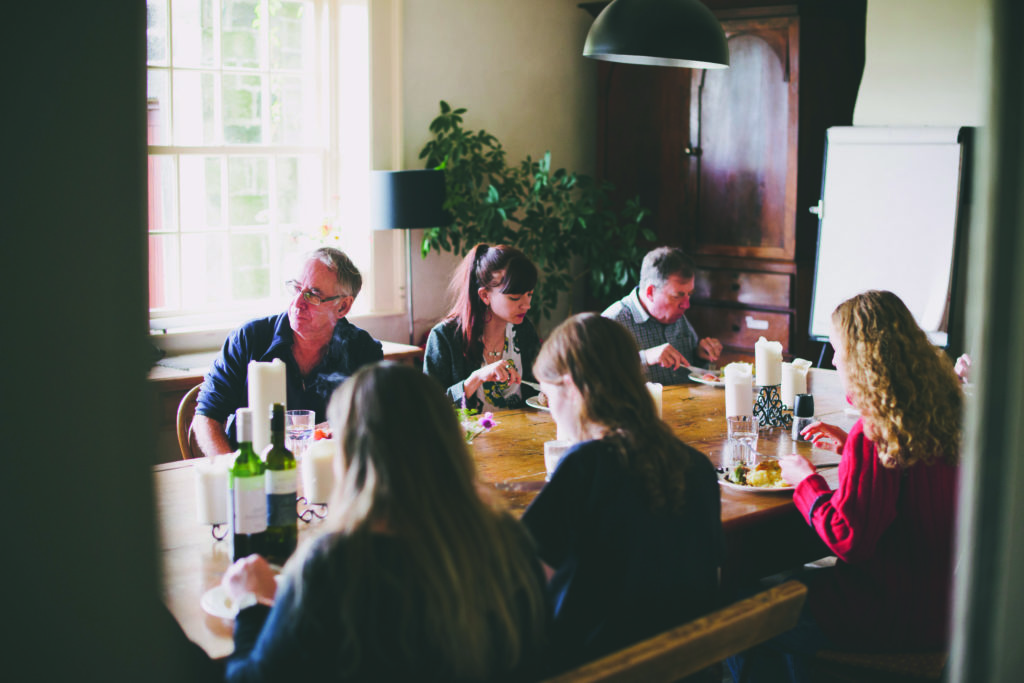 Arvon writers eating together during a course at Lumb Bank