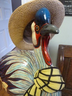 Bird sculpture with a hat and scarf on