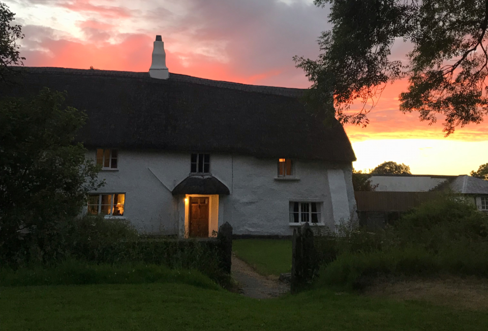 Totleigh Barton exterior of house at sunset in summer